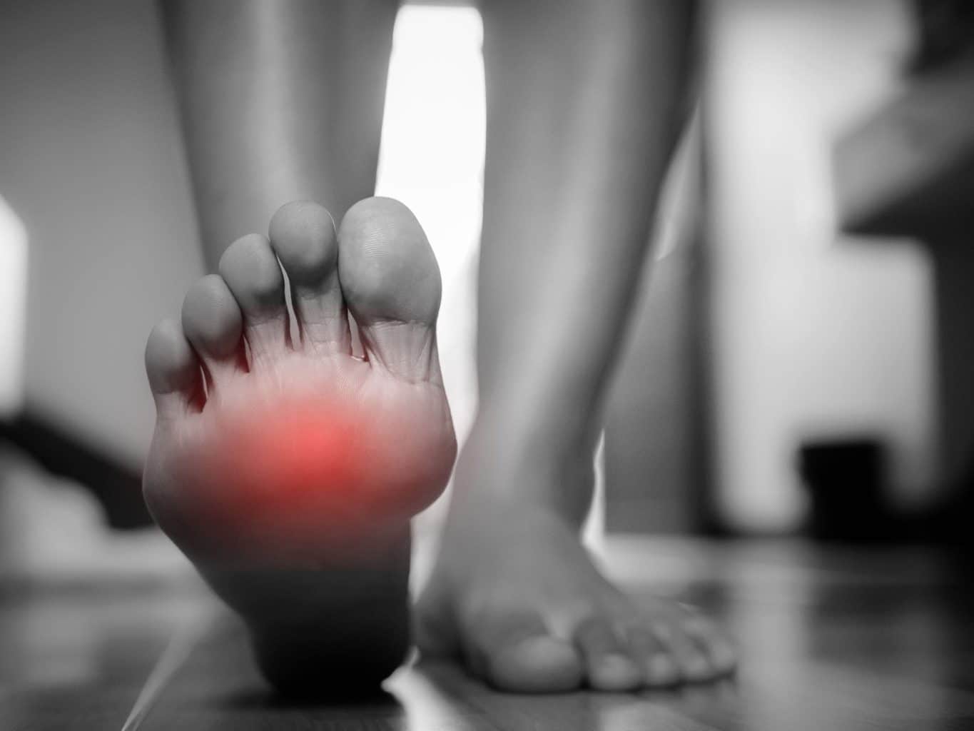 Person with a sore foot due to chronic gout and high levels of uric acid